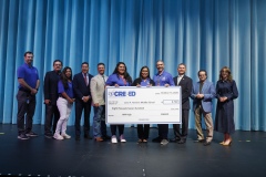 CREEED and SISD leadership recognize teachers from Jane A. Hambric Middle School with a large check as part of the 3rd Annual AIM High initiative.